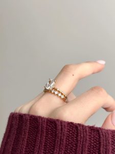 up close view of engagement ring and wedding band on finger