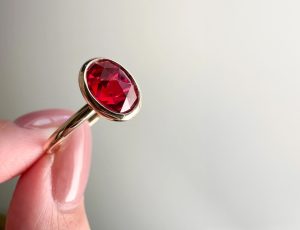 A hand with a ruby and diamond ring